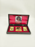 Compact Sri Sathya Sai Baba Paduka gold-colored sandals in a decorative wooden box with red interior and photograph