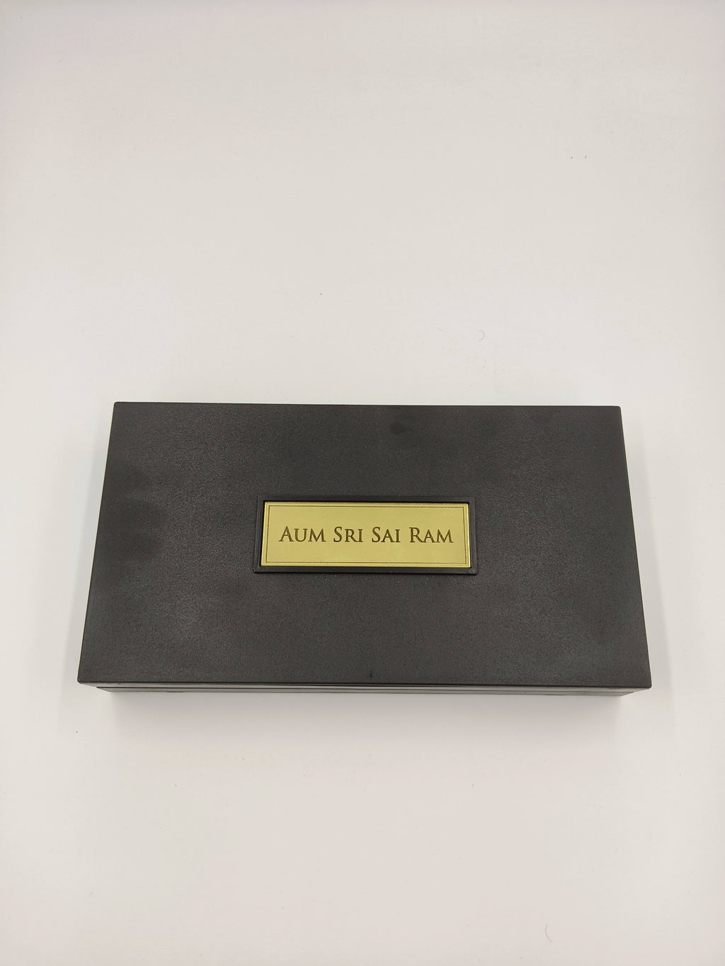 Closed dark rectangular Sri Sathya Sai Baba Paduka religious box with gold plaque