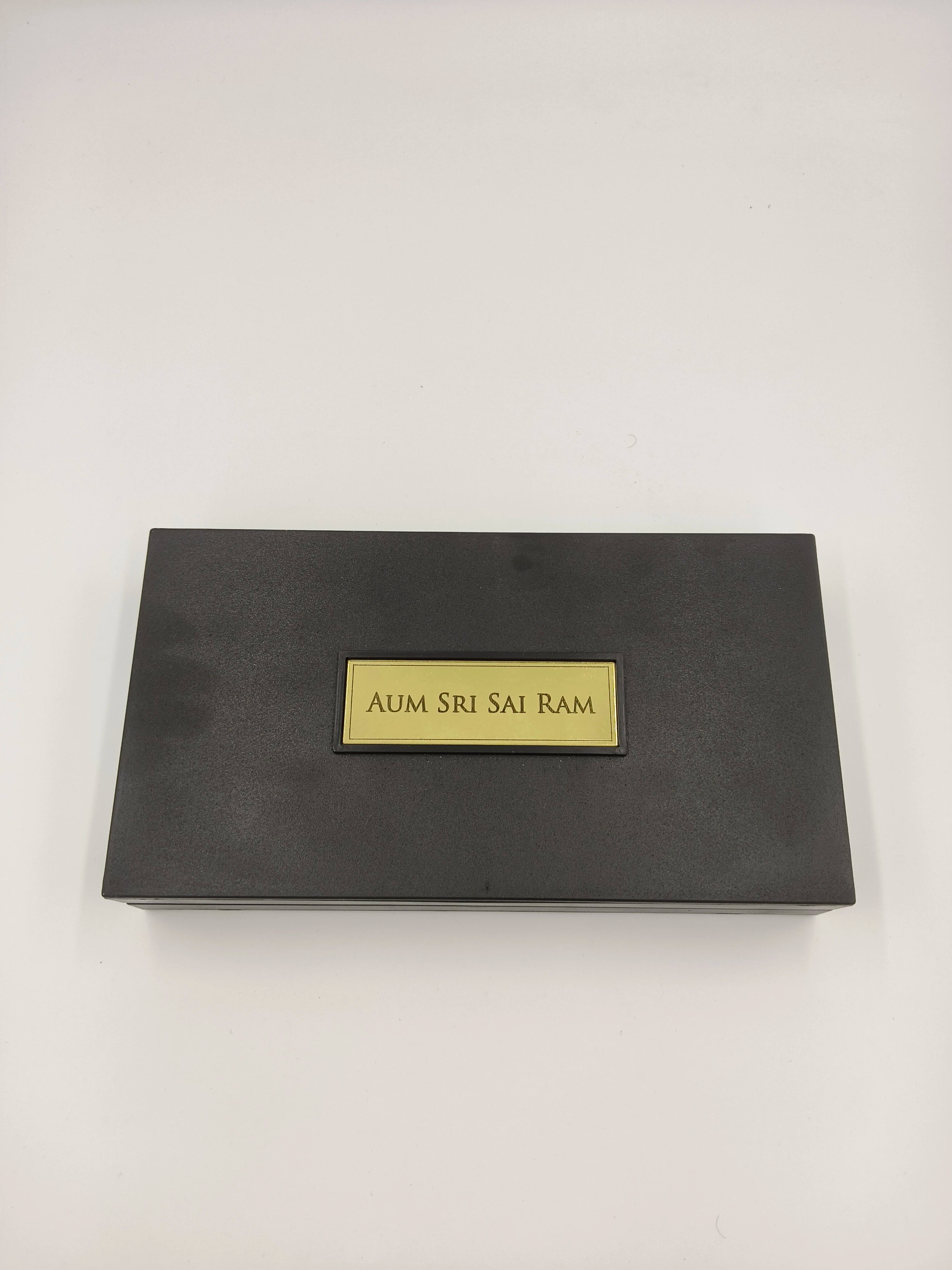 Closed dark rectangular Sri Sathya Sai Baba Paduka religious box with gold plaque