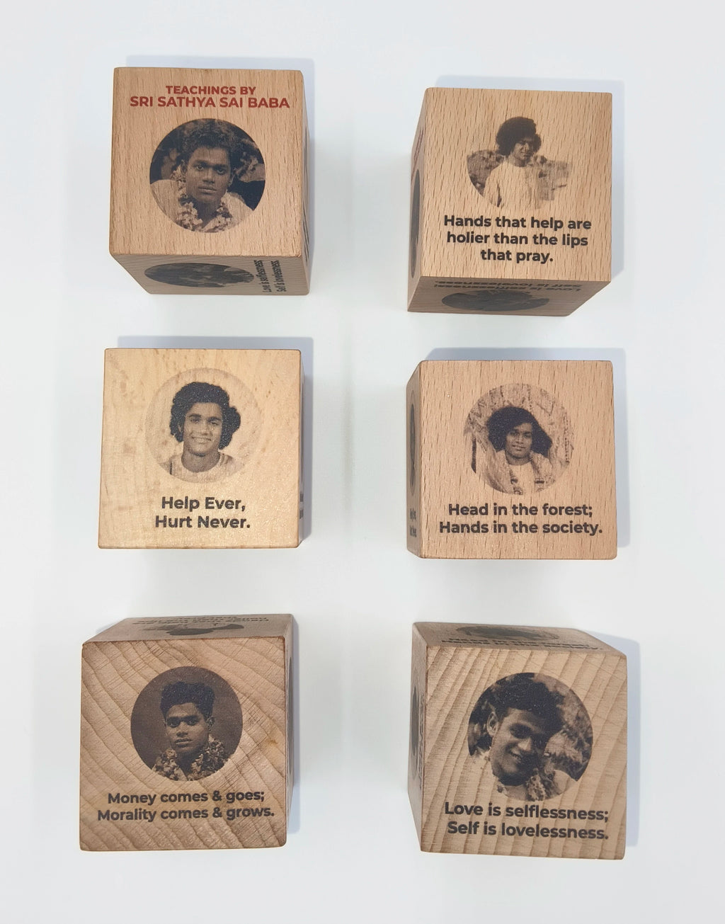 Set of six wooden cubes engraved with Sri Sathya Sai Baba's photos and teachings