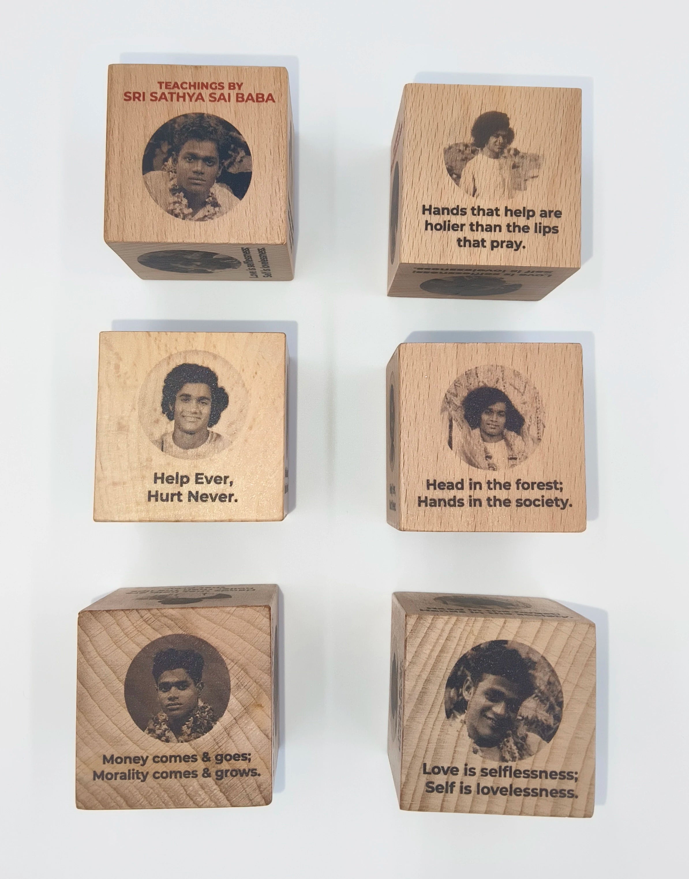 Set of six wooden cubes engraved with Sri Sathya Sai Baba's photos and teachings