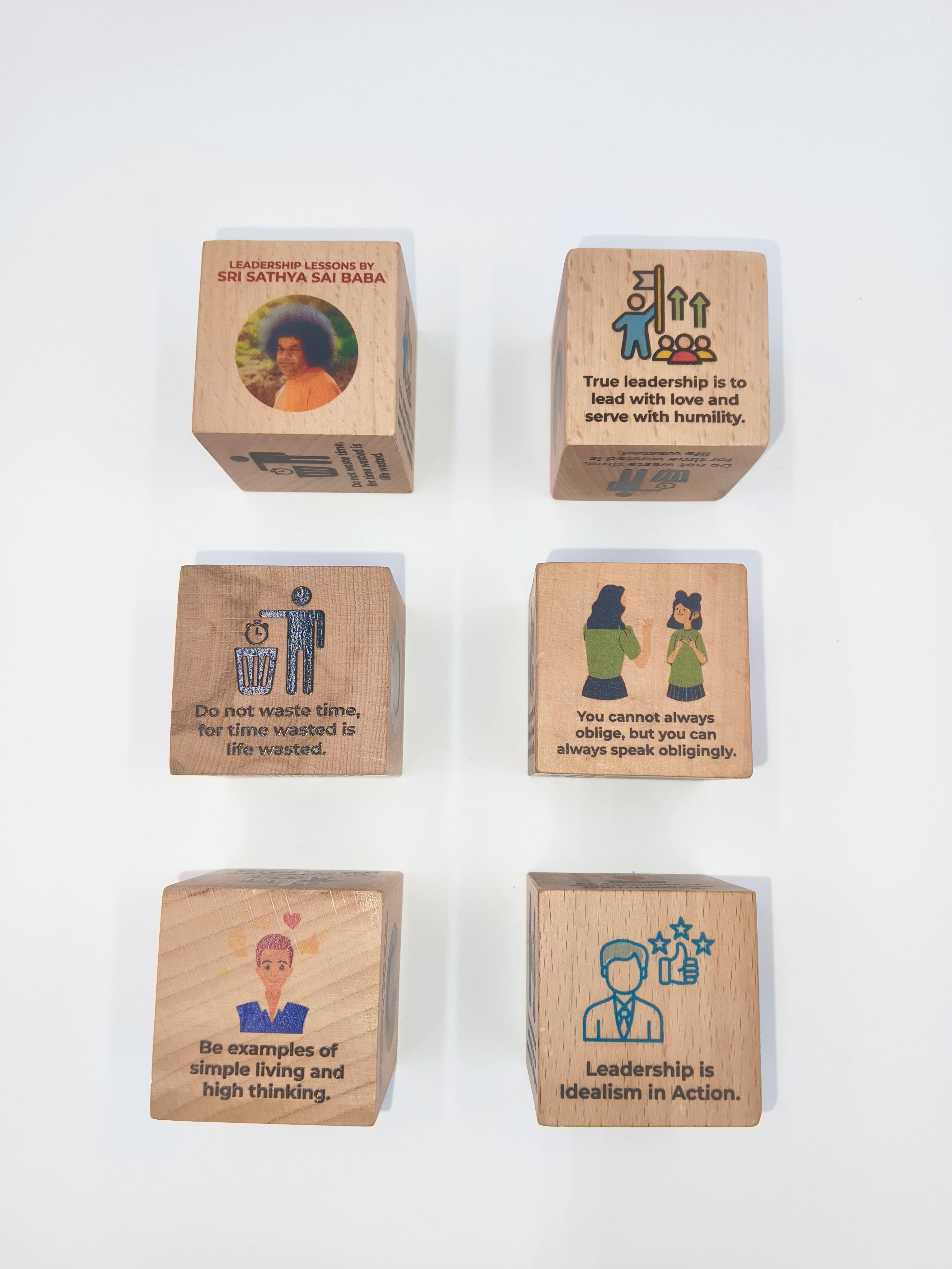 Set of six wooden cubes with leadership quotes and images inspired by Sri Sathya Sai Baba