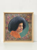 framed oil painting of Sai Baba with curly hair and orange robe on canvas