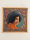 framed oil painting of Sai Baba with curly hair and orange robe on canvas