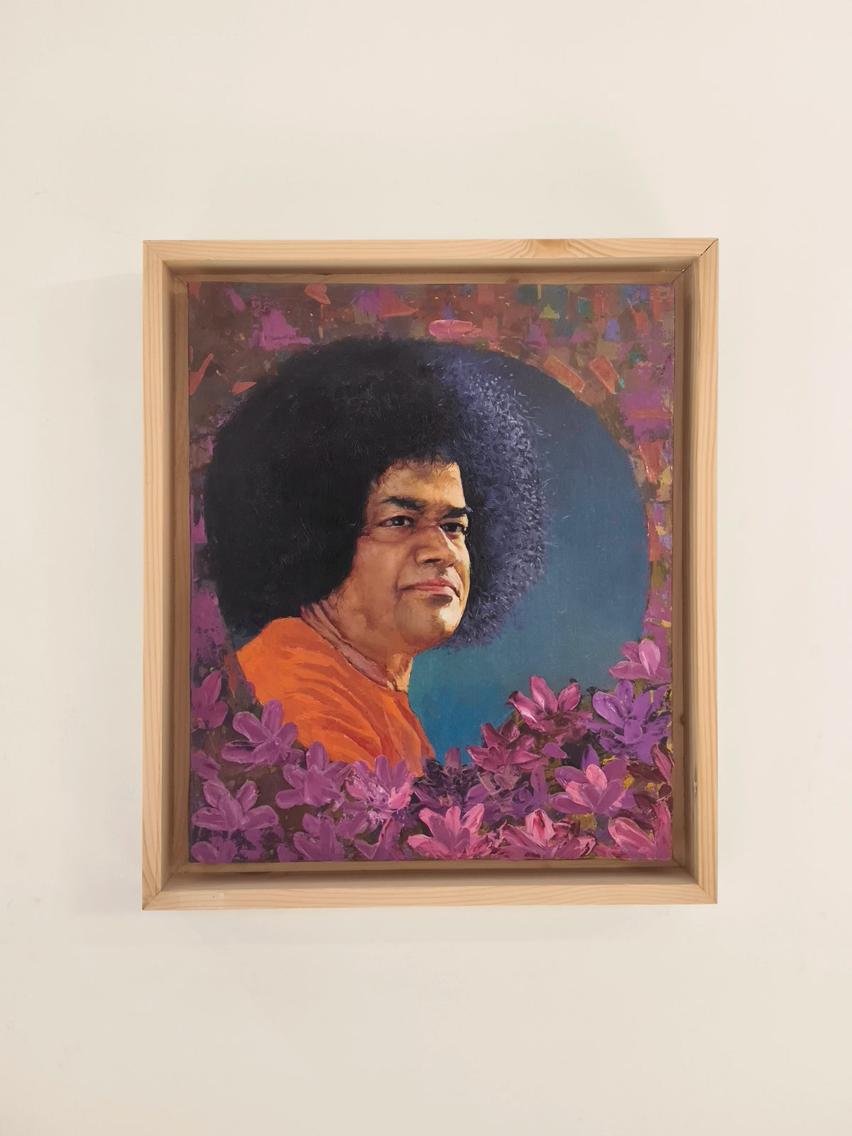 framed oil painting portrait of Sai Baba with purple flowers and colorful background