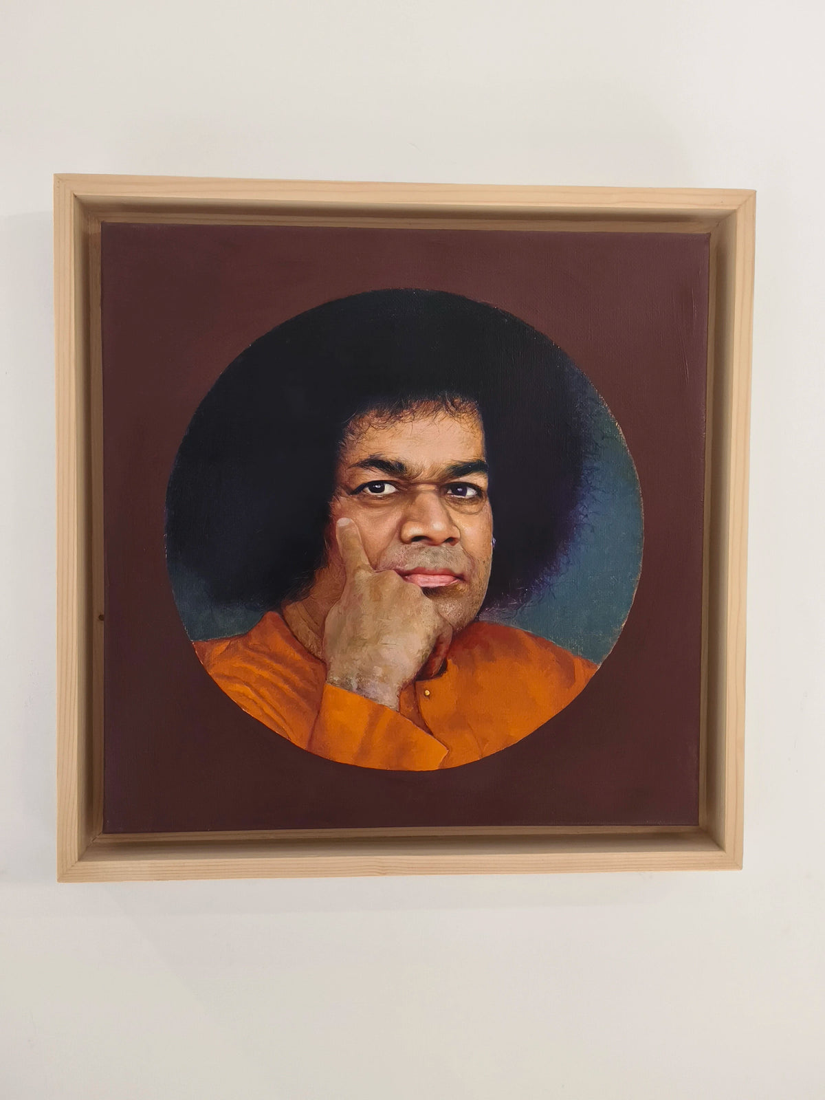 framed oil painting of Sai Baba with afro hairstyle on canvas