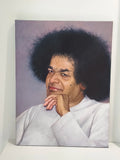 Large oil painting on canvas of Sai Baba with hand on chin against a muted background
