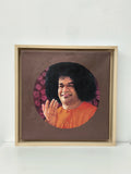Framed oil painting of Sai Baba with raised hand on canvas