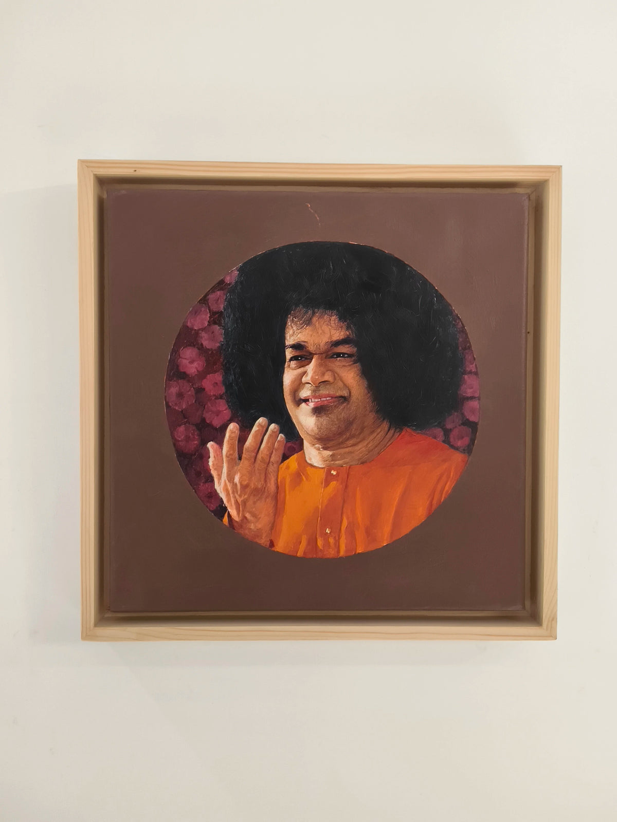Framed oil painting of Sai Baba with raised hand on canvas
