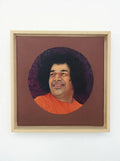 Framed oil painting portrait of Sai Baba with orange robe and dark curly hair