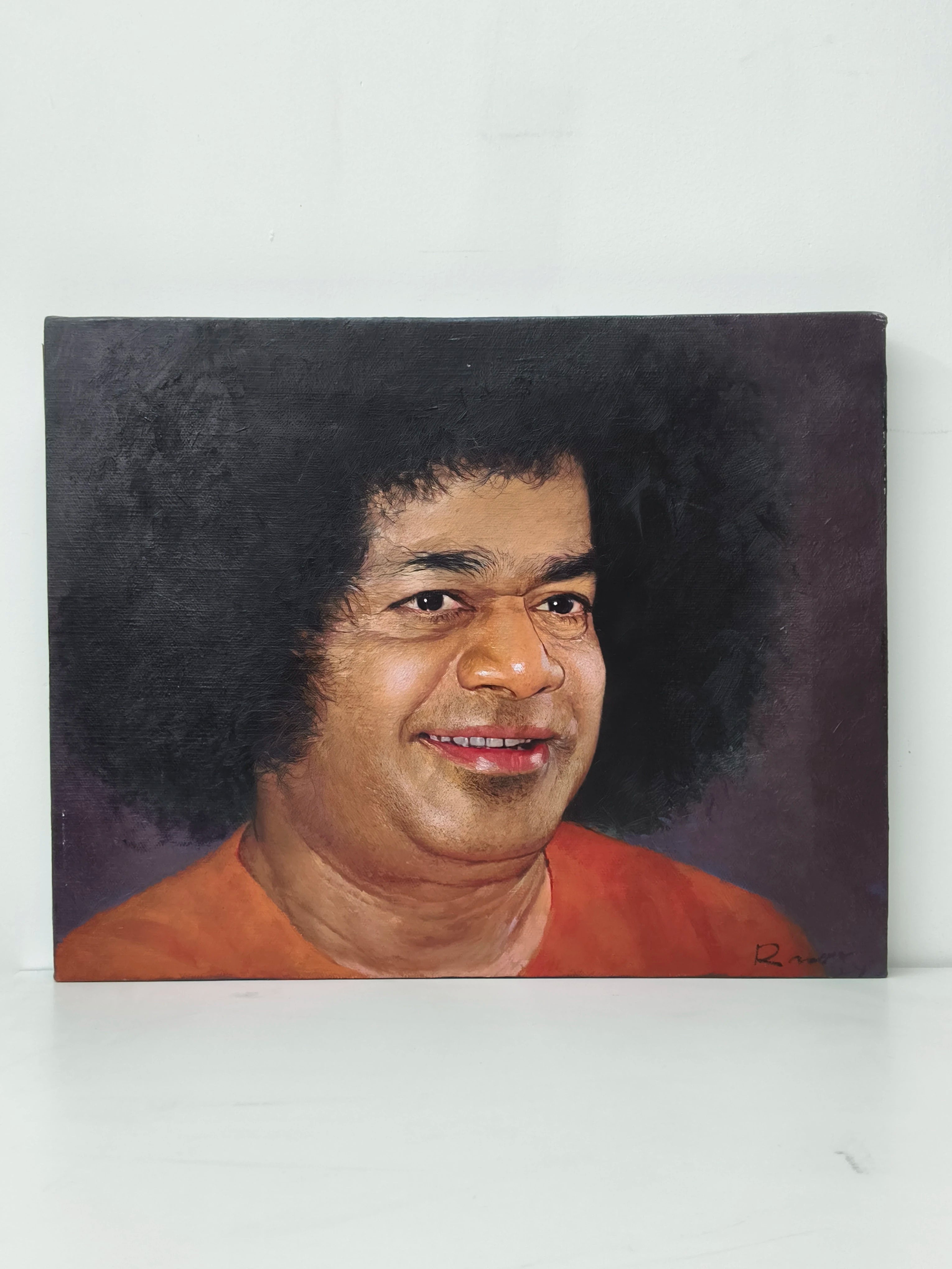 Large oil painting on canvas featuring a smiling spiritual figure with curly hair