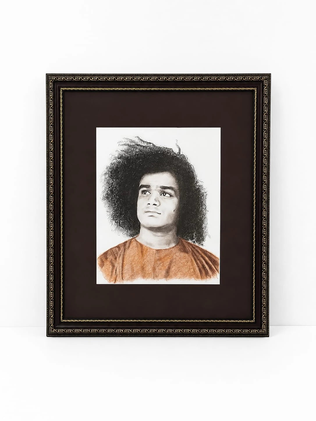 Framed painting portrait of Sai Baba with curly hair and orange robe