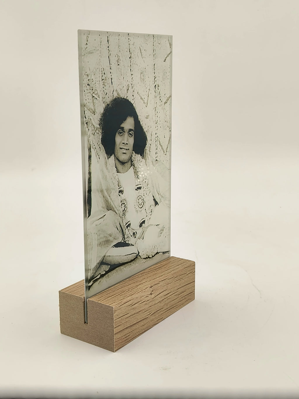 Glass photo display with wooden base featuring black and white portrait