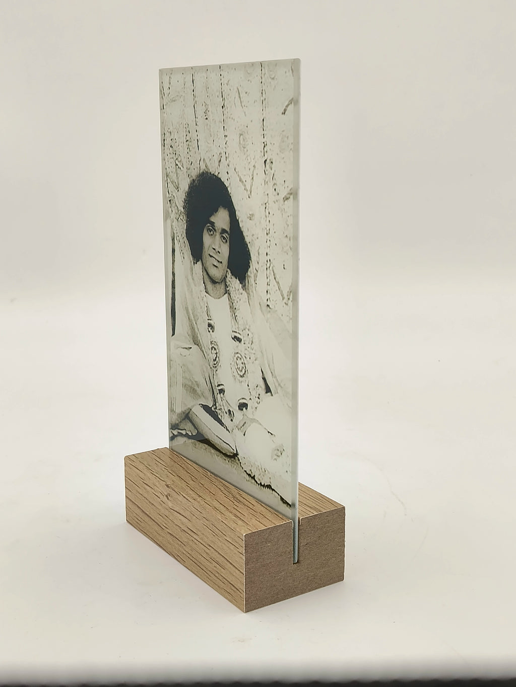 Glass photo plaque with a black and white portrait on a wooden base