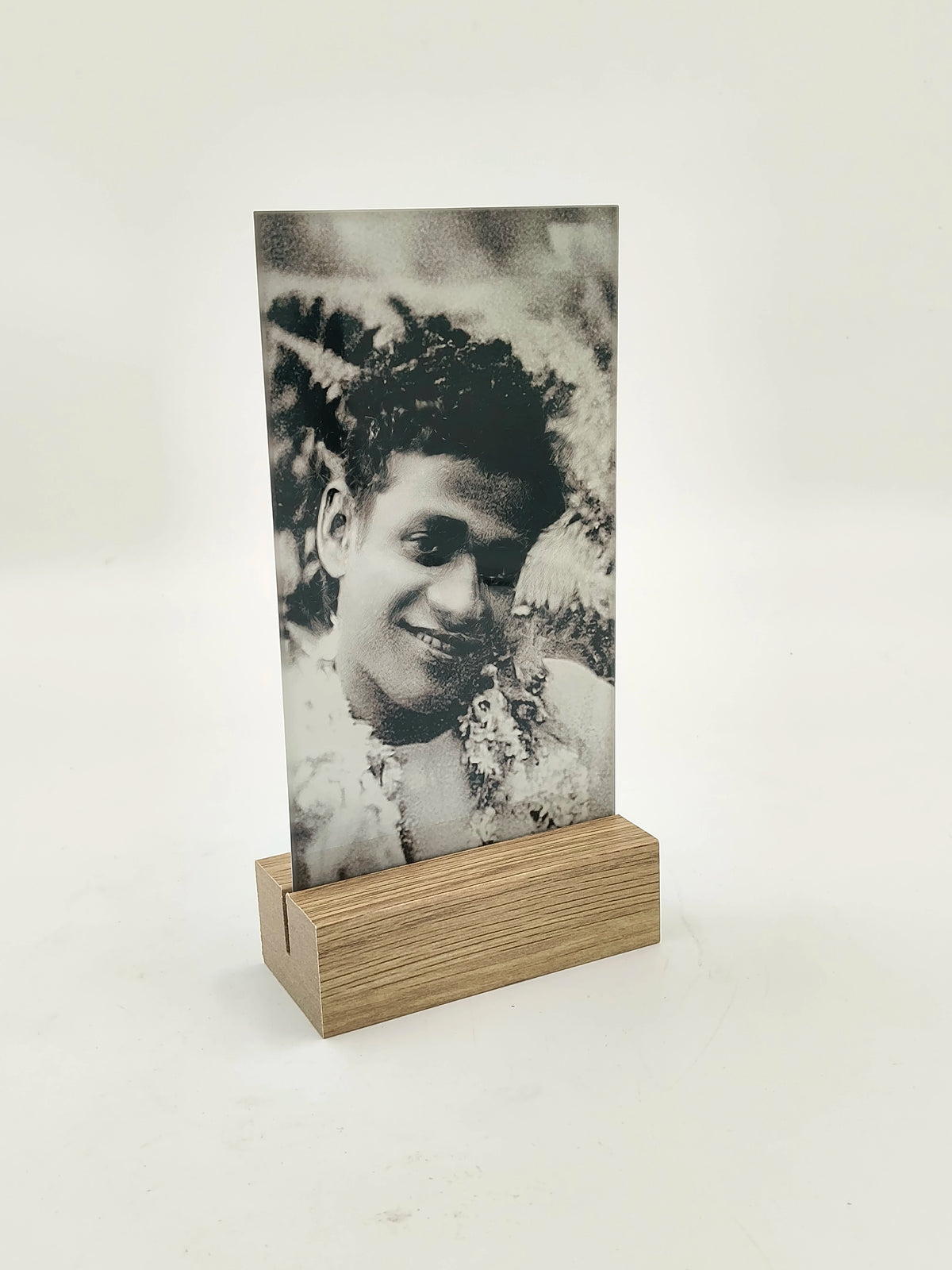 Tall glass and wood display stand with black and white photo