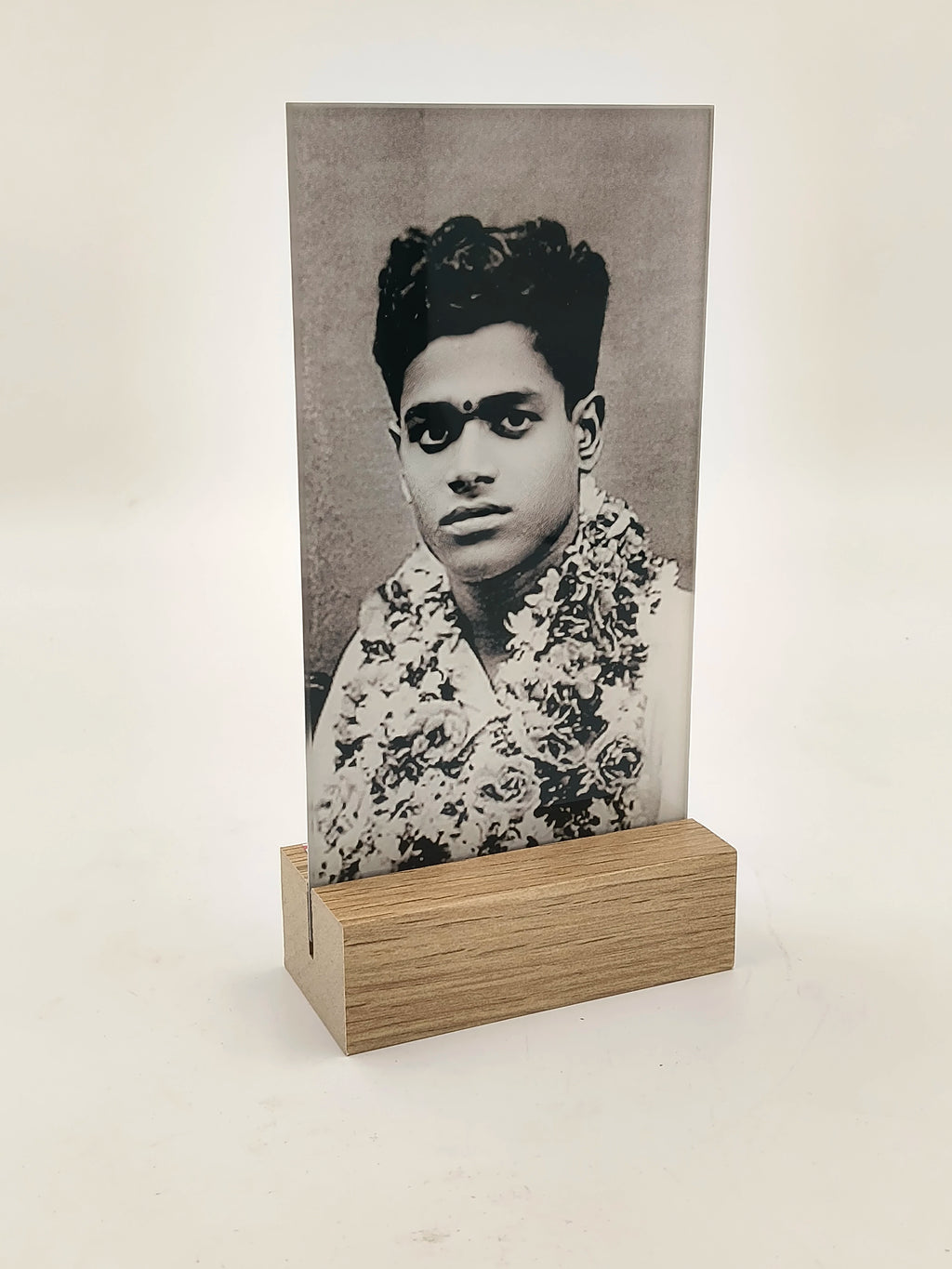 Glass and wood display frame holding a black and white portrait photograph