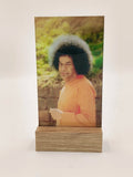 Large glass and wood display piece featuring a spiritual portrait