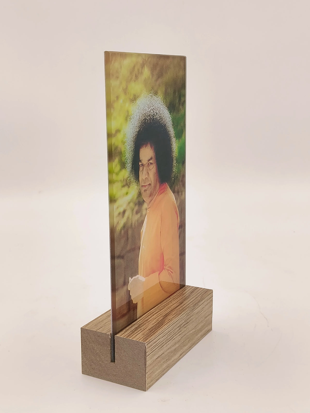 Glass display panel with spiritual figure image standing on wooden base