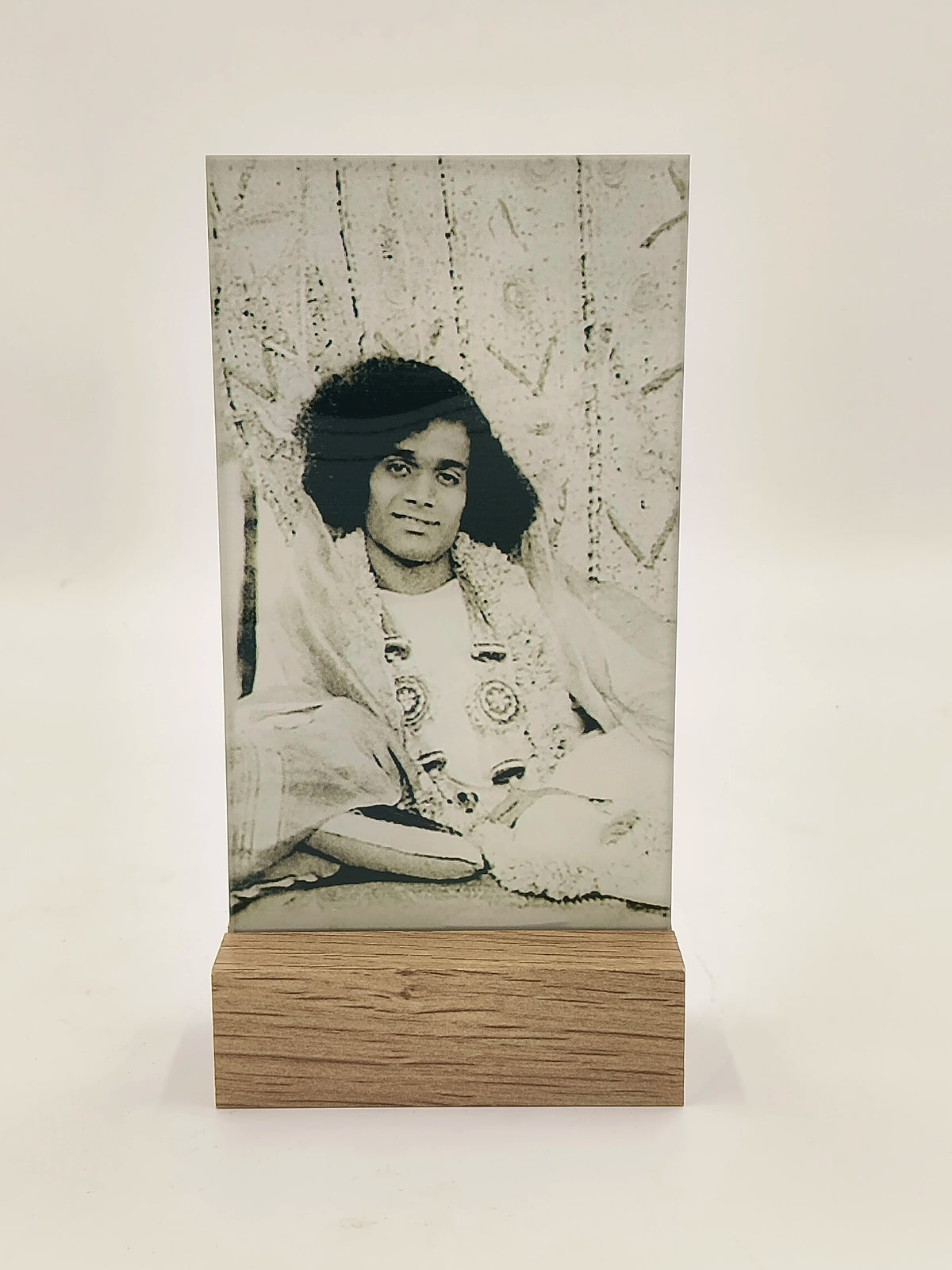 Glass and wooden display featuring a black and white portrait photograph