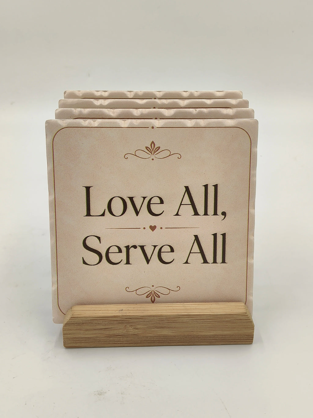 Set of ceramic coasters with inspirational quote on wooden stand