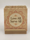 Set of ceramic coasters with spiritual quote and mandala design in wooden holder