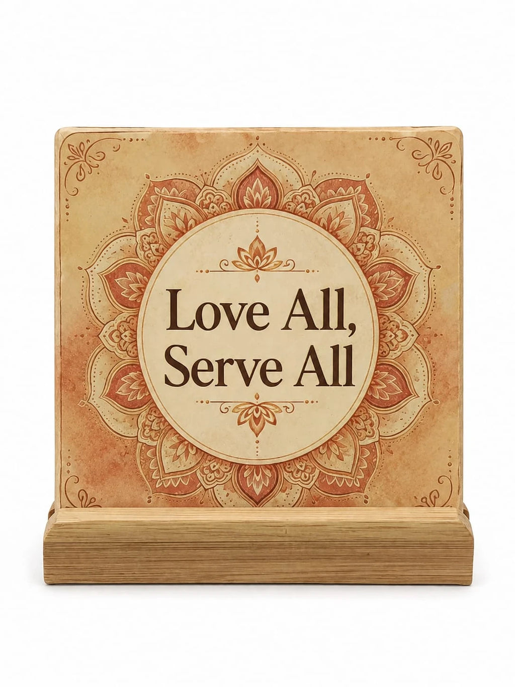 Ceramic coaster with mandala design and 'Love All, Serve All' text, displayed on wooden stand
