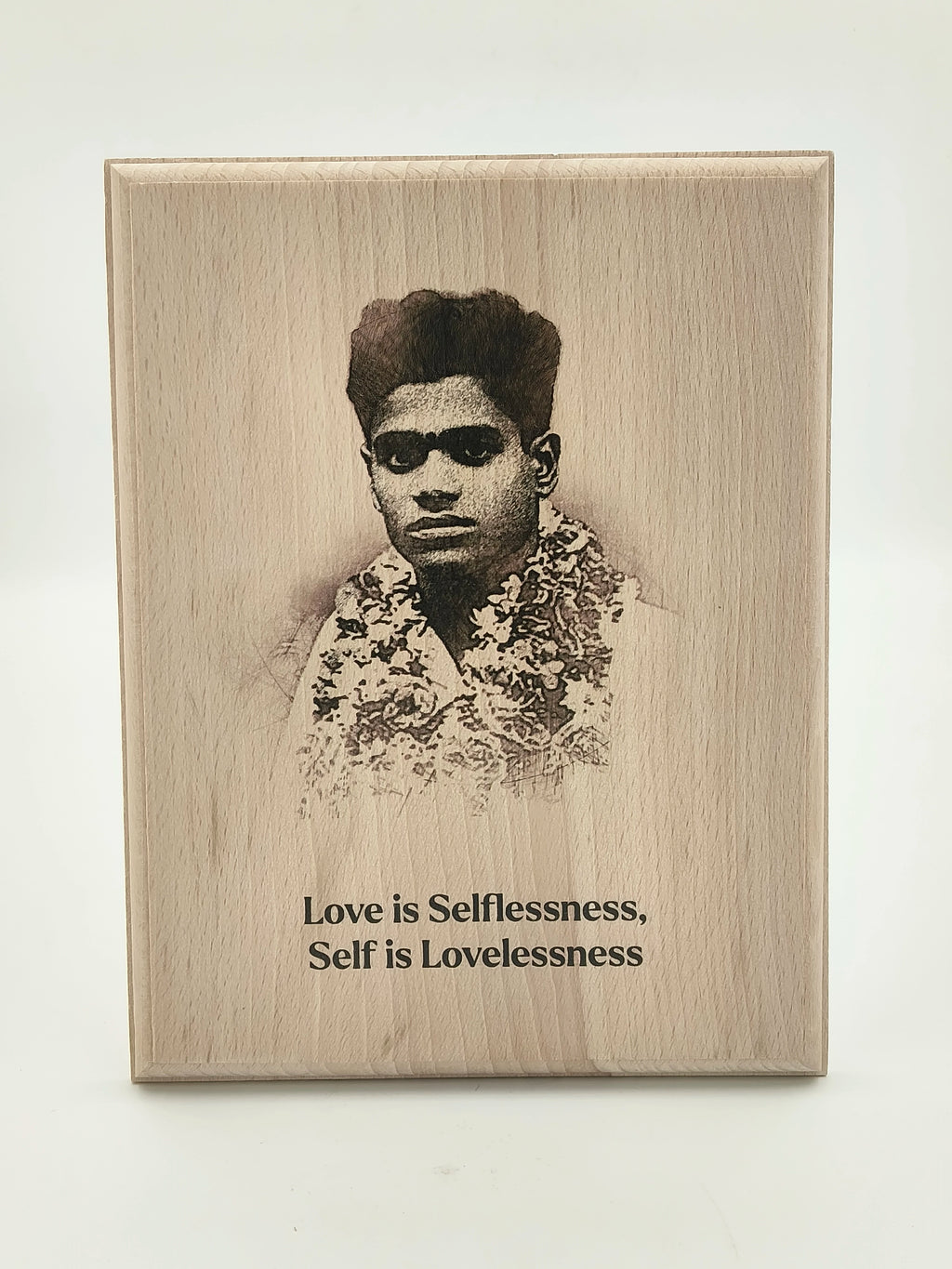 Wooden plaque with engraved portrait and inspirational quote about love and selflessness